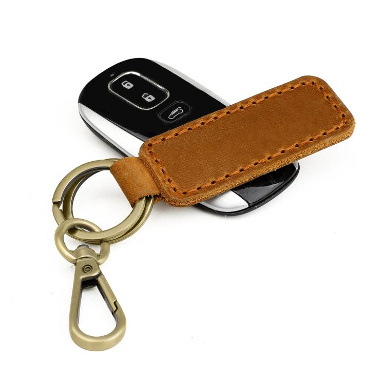 Tan leather car key chain with brass ring and key fob partially visible