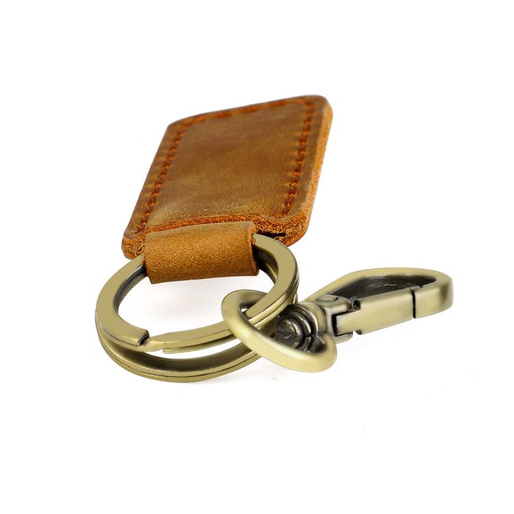 Tan leather car key chain with brass ring and spring-style metal clasp