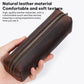 Brown leather pencil case held in hand with zipper and stitched trim