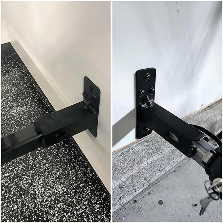 Black bicycle wall-mounted bracket installed with clamp arm holding the bicycle