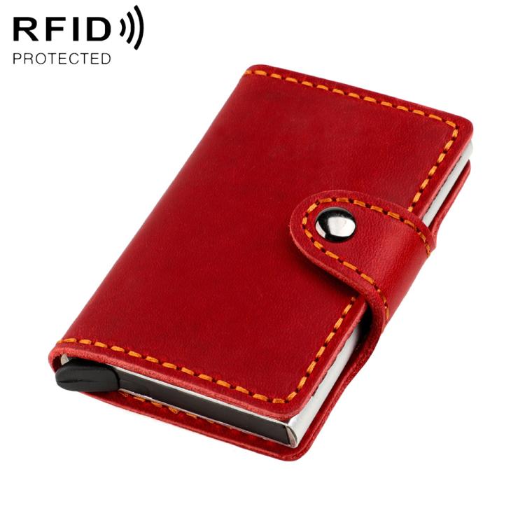 Red leather card holder with snap strap and orange-stitched edges, slim fold-over
