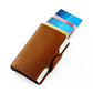 Brown RFID card holder with snap-open aluminum body and visible card slots.