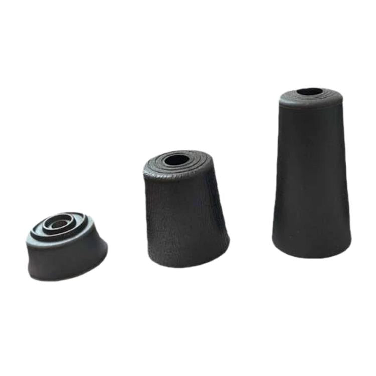 Assorted black plastic furniture support feet in different heights, each with central hole