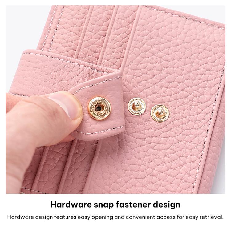 Light pink leather card holder with round gold snap fasteners on inner panel