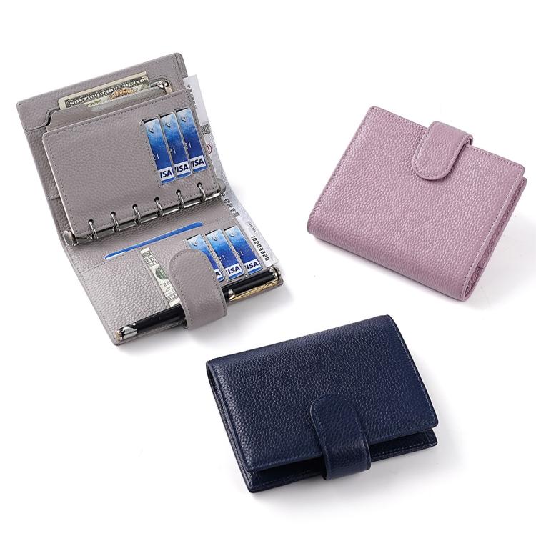 Assorted leather-look passport holders in gray, lavender, and navy with flap closures