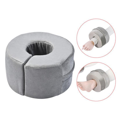 Gray round ankle support cushion with center opening and stitched edges