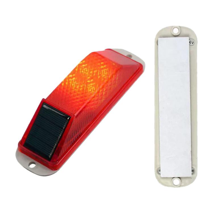 Solar LED warning light with red lens, white base, and black solar panel