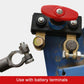 Close-up of car battery disconnect switch with red lever and copper cable terminals