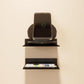 Wall-mounted acrylic shelf rack, black, supporting a smart display device on top
