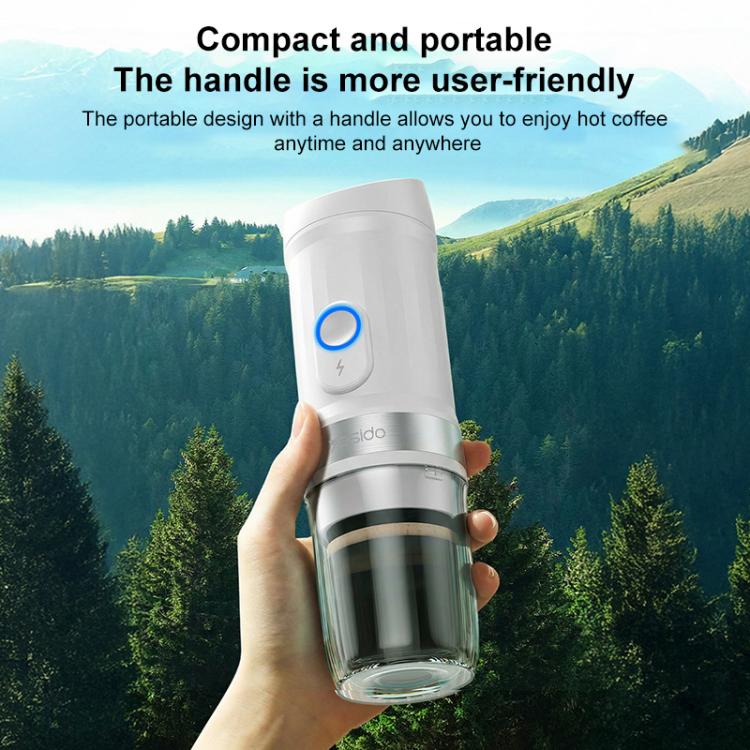 White handheld electric coffee maker with carry grip and clear glass cup