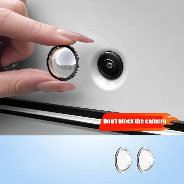 Round clear lens protector with black ring, held over a car rear camera lens
