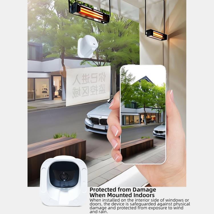 White security camera near a window with a smartphone showing the app view