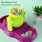 Bee balance sensory toy close-up with green honey pot and purple tray filled with bee pieces