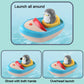 Penguin boat bath toy showing launch positions with red water-spraying hands