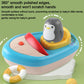 Round-edged penguin boat bath toy with blue base, red sprayer, and grey penguin figure