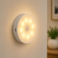 Wall-mounted round LED induction night light with warm light glow
