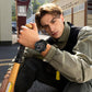 Black rugged sports watch on a wrist with textured band and round face