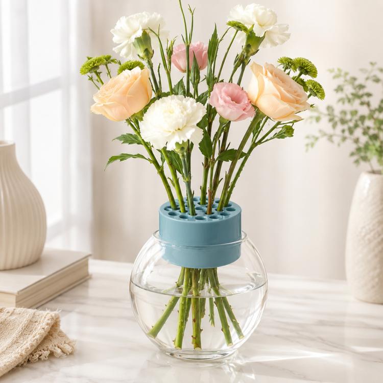 Blue plastic flower stem holder cylinder with round stem holes on a clear glass vase
