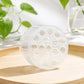 Transparent plastic flower stem holder cylinder with circular grid of stem openings