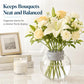 Grey plastic flower stem holder on a clear glass vase with white bouquet
