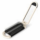 2-in-1 folding hairbrush with mirror, white frame and black bristles on base