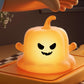 Glow orange pumpkin ghost silicone night light with carved grin face