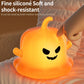 Pumpkin ghost silicone night light, softly glowing orange smiling face