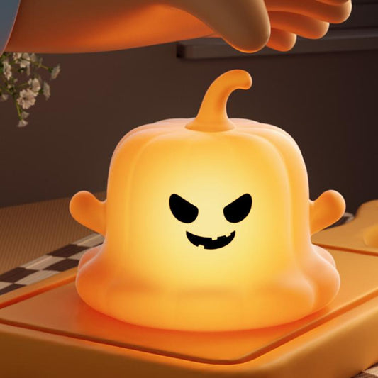 Glow orange pumpkin ghost silicone night light with carved grin face