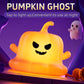 Orange silicone pumpkin ghost night light with smiling face, lit for Halloween