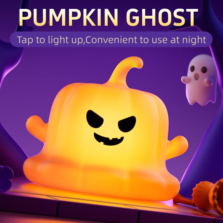 Orange silicone pumpkin ghost night light with smiling face, lit for Halloween
