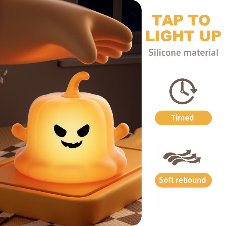 Orange silicone pumpkin ghost night light under a hand, tap to light