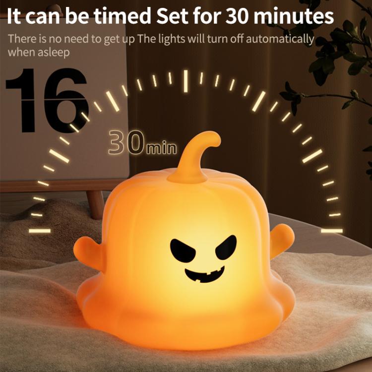 Pumpkin ghost silicone night light, glowing orange jack-o’-lantern face