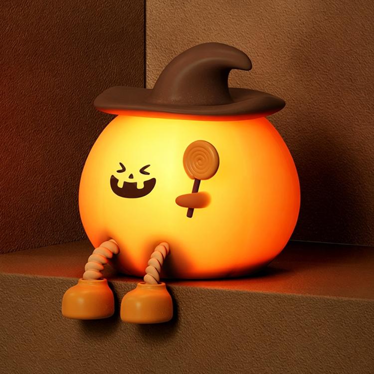 Silicone pumpkin night light with smiling jack-o’-lantern face, orange glow and brown hat