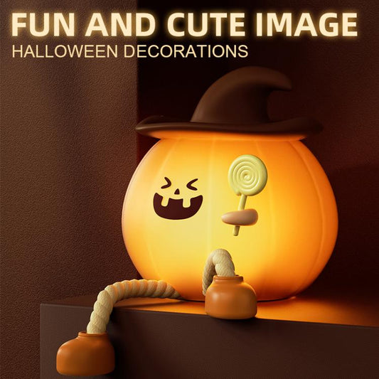 Orange silicone pumpkin night light with jack-o’-lantern face, holding a lollipop, brown hat