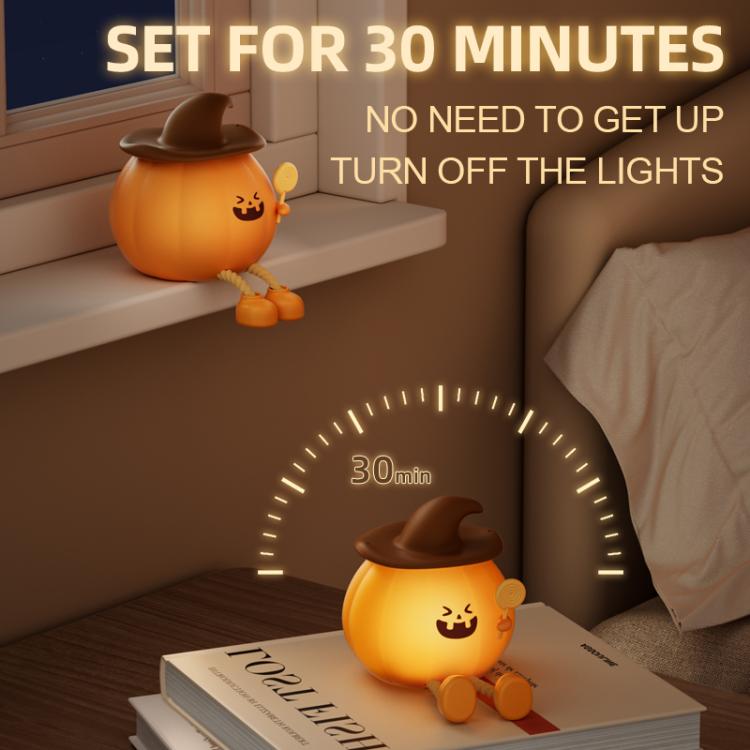 Pumpkin silicone night light with jack-o’-lantern face, brown hat, sitting on a tabletop