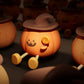 Close-up of orange silicone pumpkin night light with jack-o’-lantern face, brown hat, lollipop detail