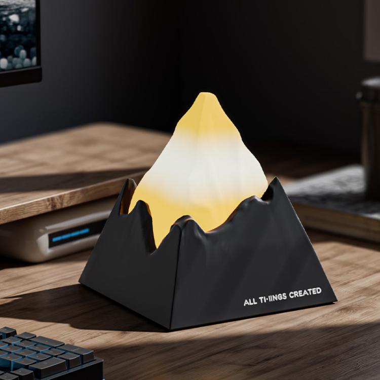 Dark grey mini volcano aroma diffuser night light with warm yellow glow peak