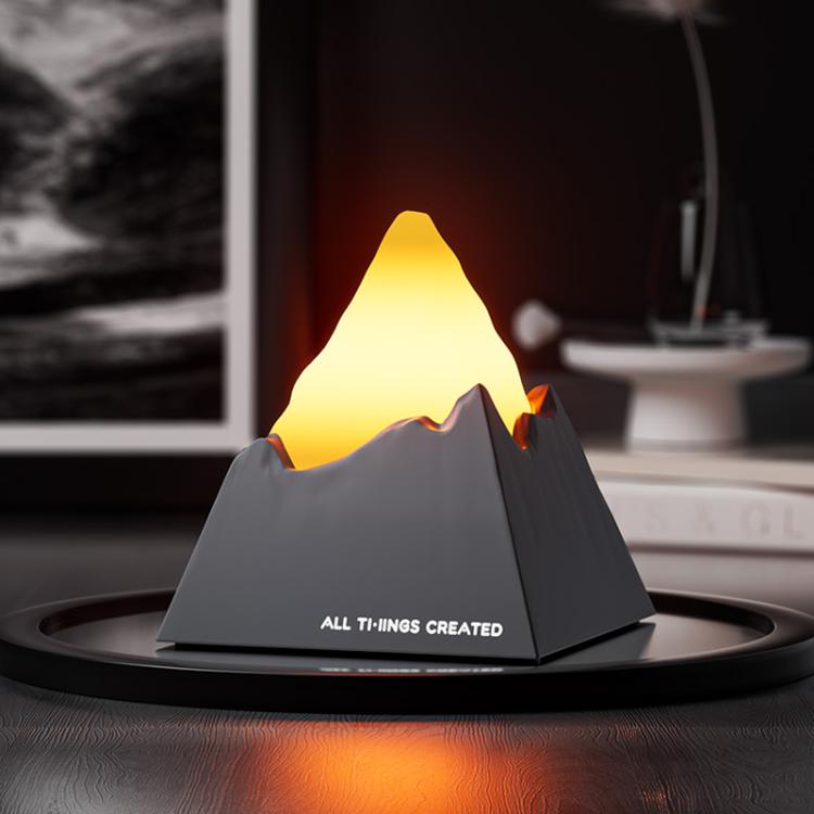 Dark grey mini volcano aroma diffuser night light with amber glowing peak