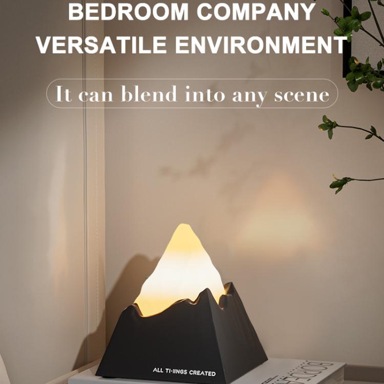 Mini volcano aroma diffuser night light with warm flame glow on dark base