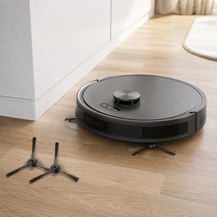 Robot vacuum with three black side brushes on light wood floor