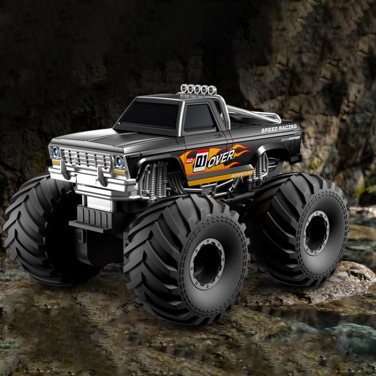 Black amphibious 4WD RC monster truck front three-quarter view with big tread tires.