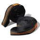 Rolled black loop strap with orange stitch detailing and woven edges