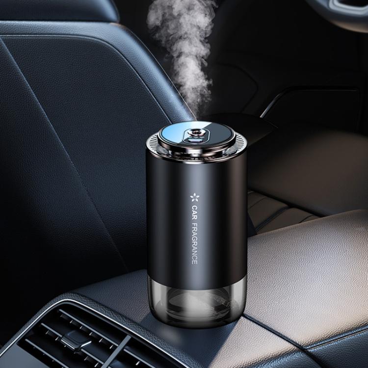 Car aroma diffuser with black cylindrical body and silver top, producing visible mist