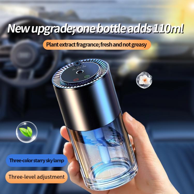 Car aroma diffuser held in hand with stainless body and clear base reservoir