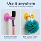 Pink and yellow suction holders for toothbrush and bath sponge