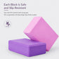 Stacked yoga blocks in pink and purple with textured anti-slip surface
