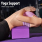 Purple yoga block supporting a seated stretch pose