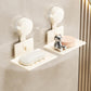 Two cream suction cup soap and sponge holders with drainable metal trays