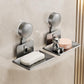 Two grey suction cup soap and sponge holders with drainable metal trays