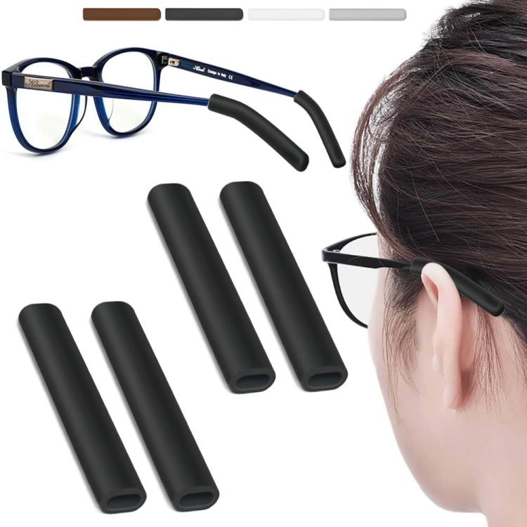 Soft silicone eyeglass ear pads, black pair shown with eyeglass temple and wearer.